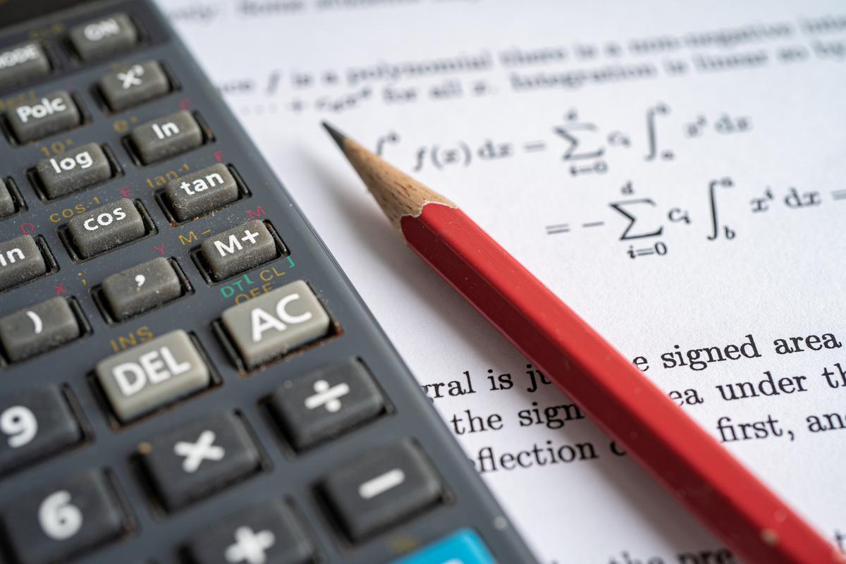 Pencil and Calculator on Mathematic Formula Exercise Test Paper