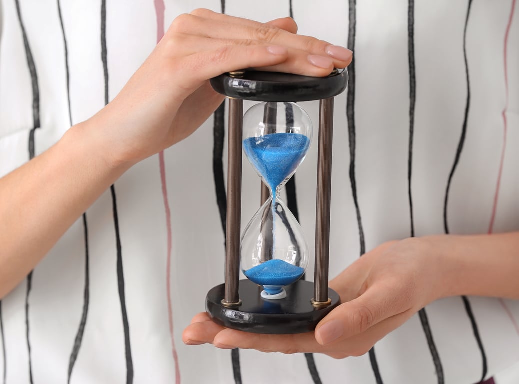 Woman Holding Hourglass, Closeup. Time Management Concept